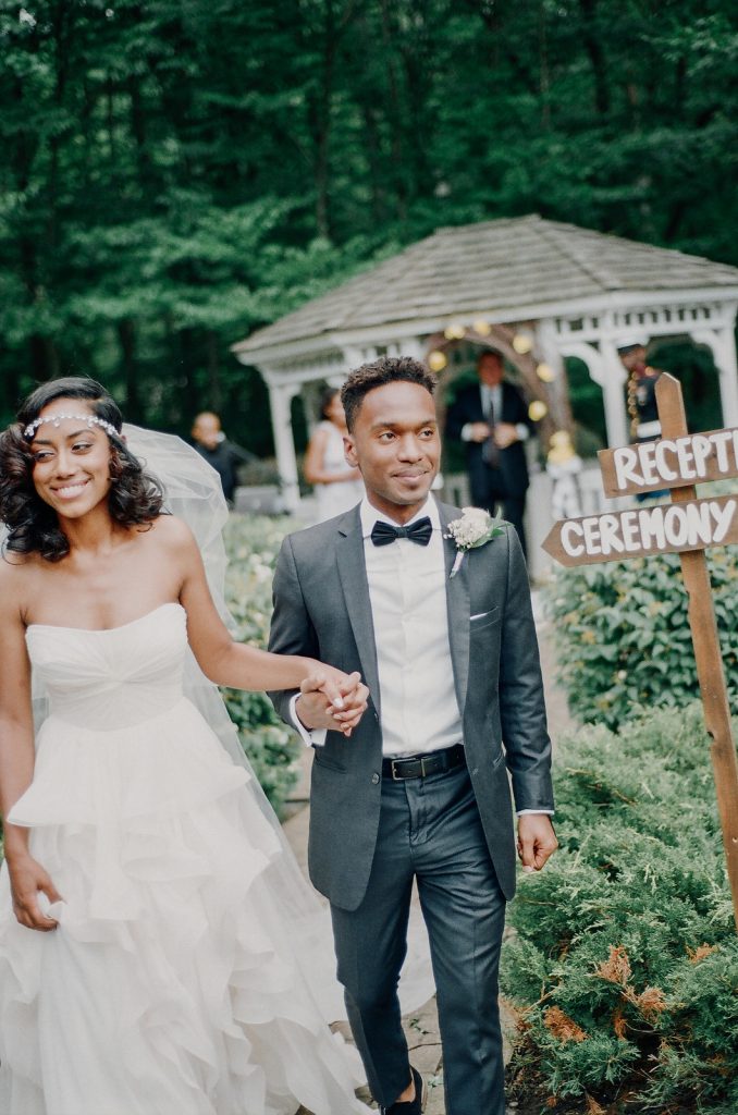young black couple walking holding hands