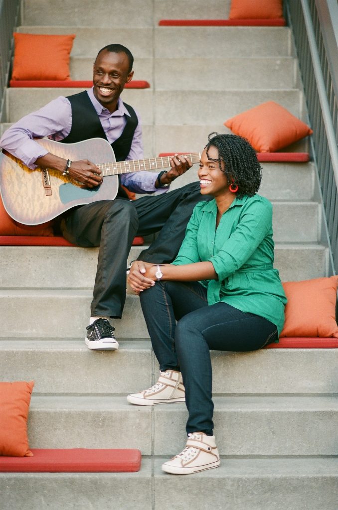 nyc engaged couple playing guitar