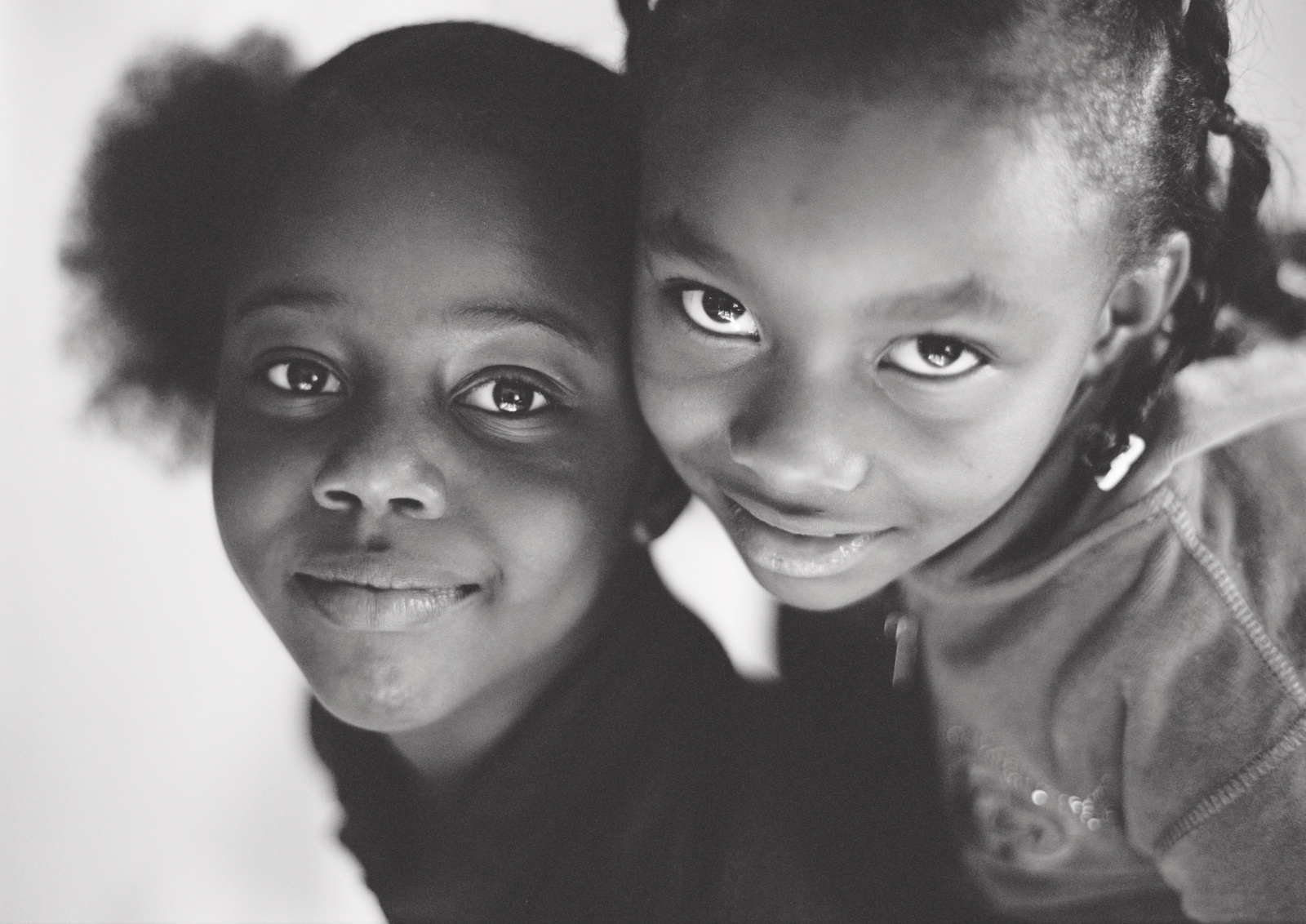 bw photo of 2 black girl cousins white background